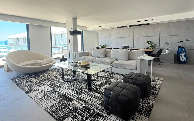 Bright furnished living room with clean floors and seating