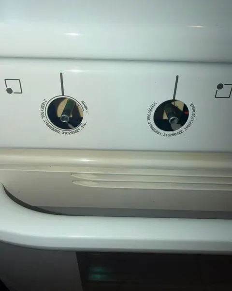 After: white oven control panel and door handle with two control knobs removed.