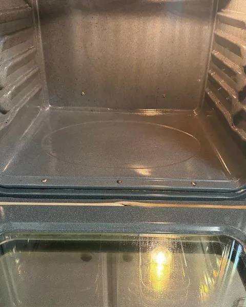 After: oven interior and door glass with the dark grease streaks removed.