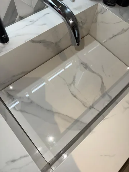 Rectangular marble bathroom basin with a chrome faucet.